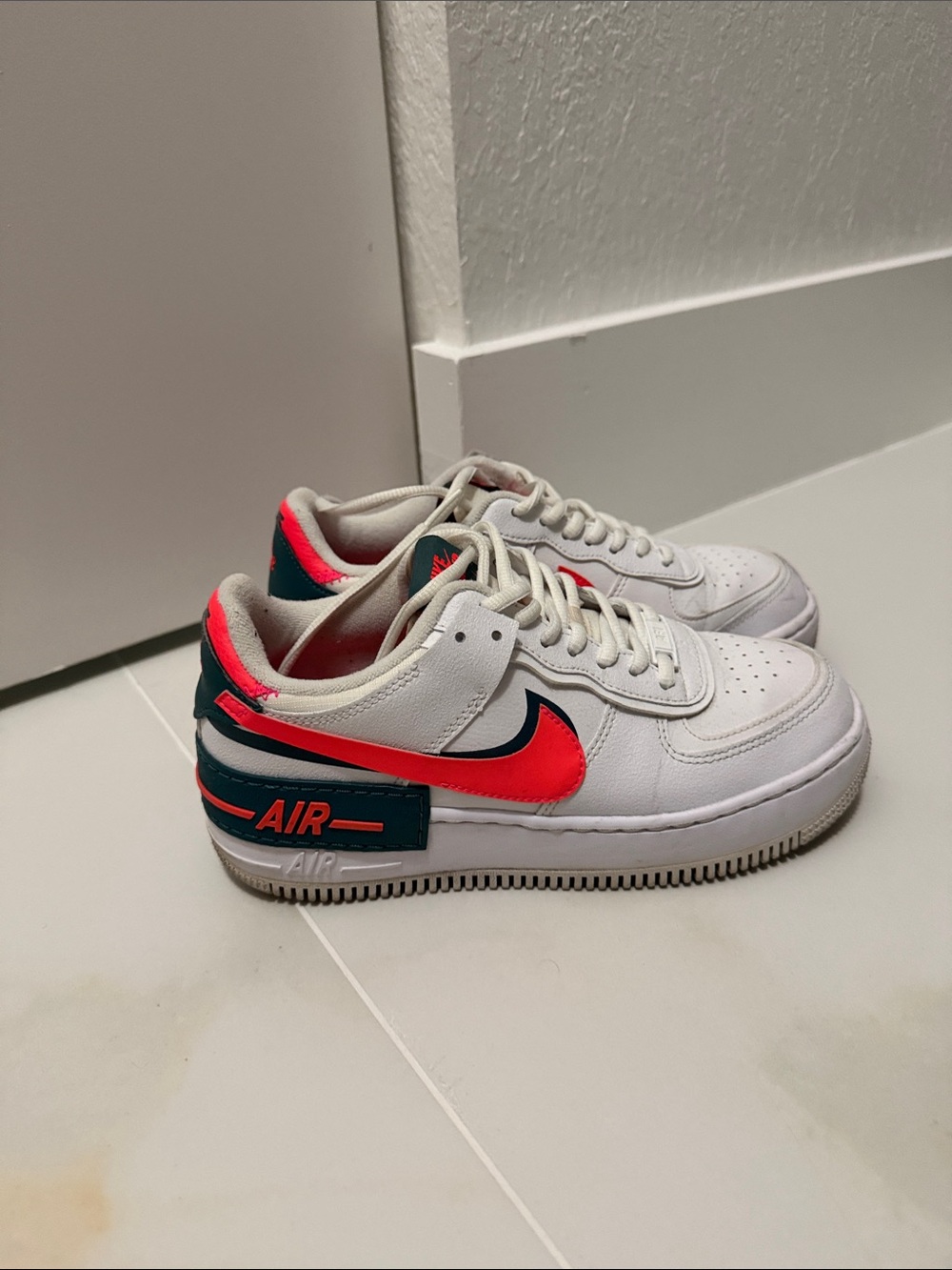 Nike Kids White Sneakers with Bright Red Swoosh and Dark Teal Accents